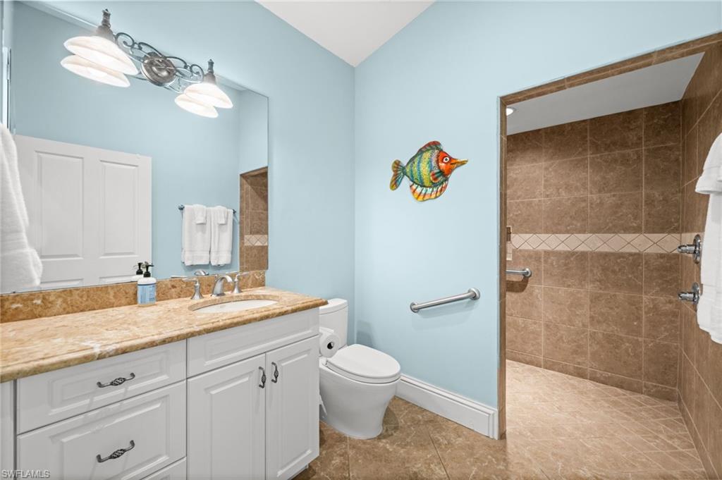 1963 Bethany Place Naples, FL 34109 - Photo 42 of 50 Spacious walk-in shower, extended vanity, and coastal accents throughout.