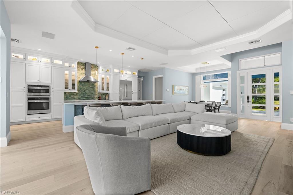 1963 Bethany Place Naples, FL 34109 - Photo 4 of 50 A spacious great room flows seamlessly into the chef’s kitchen — perfect for everyday gathering and entertaining.