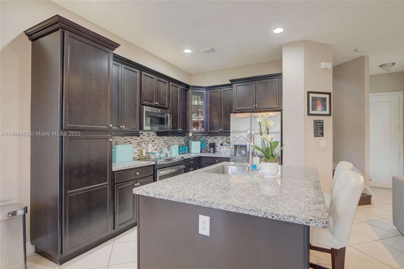 3308 West 95th Terrace Hialeah, FL 33018 - Photo 11 of 43 a kitchen with stainless steel appliances granite countertop a refrigerator a stove a sink and a refrigerator