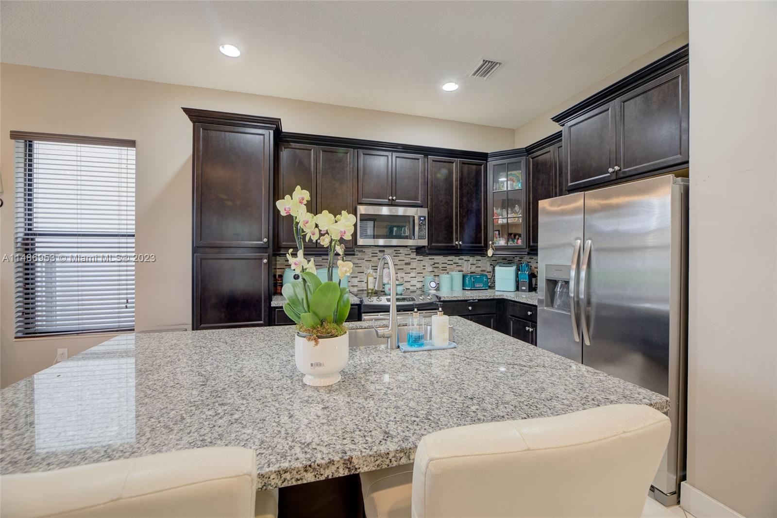3308 West 95th Terrace Hialeah, FL 33018 - Photo 13 of 43 a kitchen with a refrigerator sink and stove