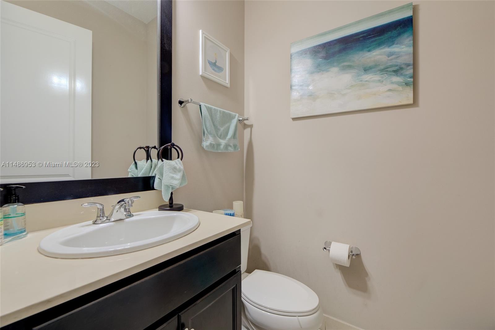 3308 West 95th Terrace Hialeah, FL 33018 - Photo 14 of 43 a bathroom with a sink and a mirror