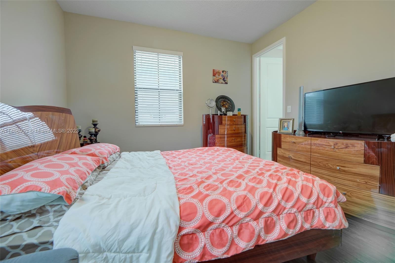 3308 West 95th Terrace Hialeah, FL 33018 - Photo 18 of 43 a bedroom with a bed and a flat screen tv