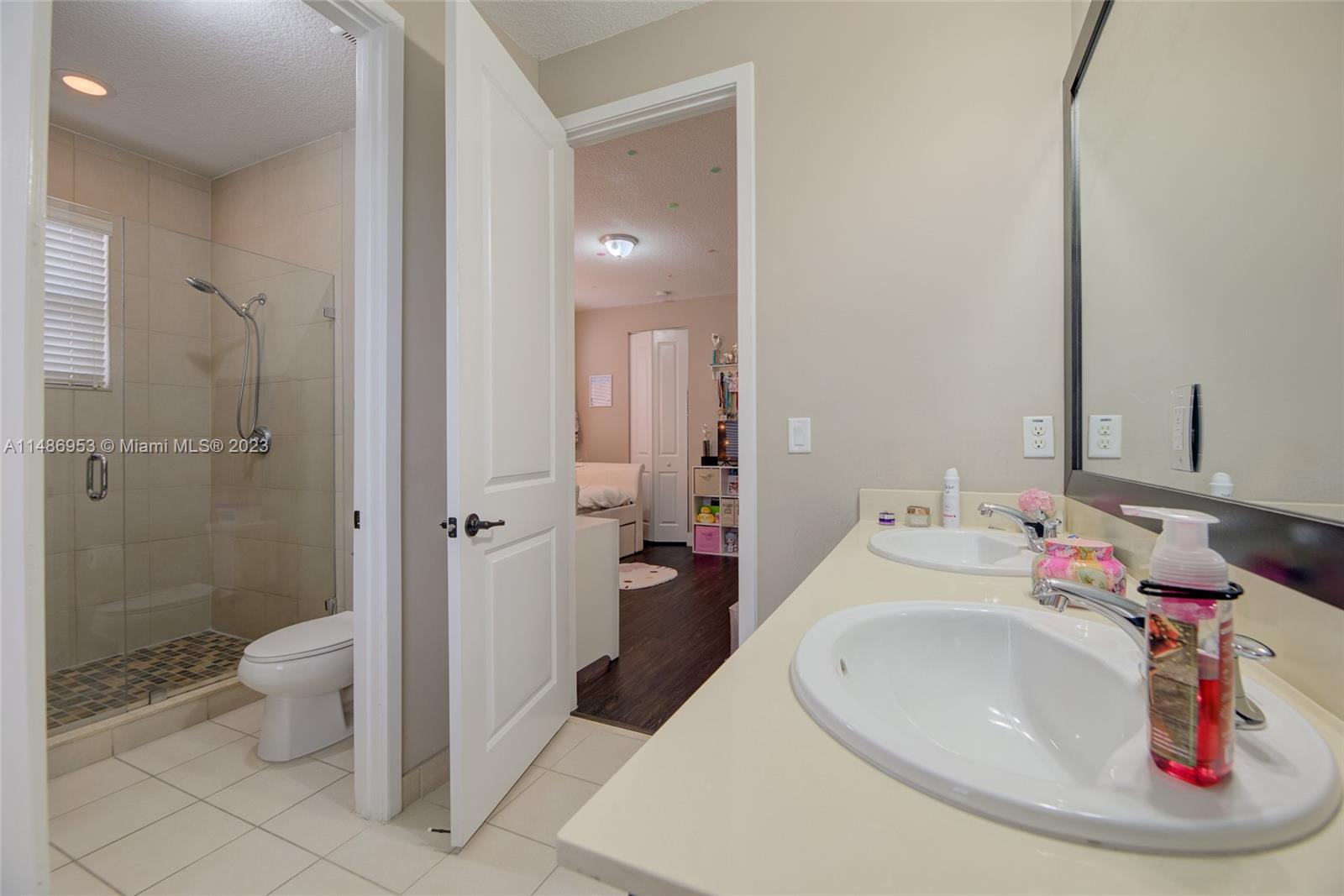 3308 West 95th Terrace Hialeah, FL 33018 - Photo 21 of 43 a bathroom with a sink and a mirror