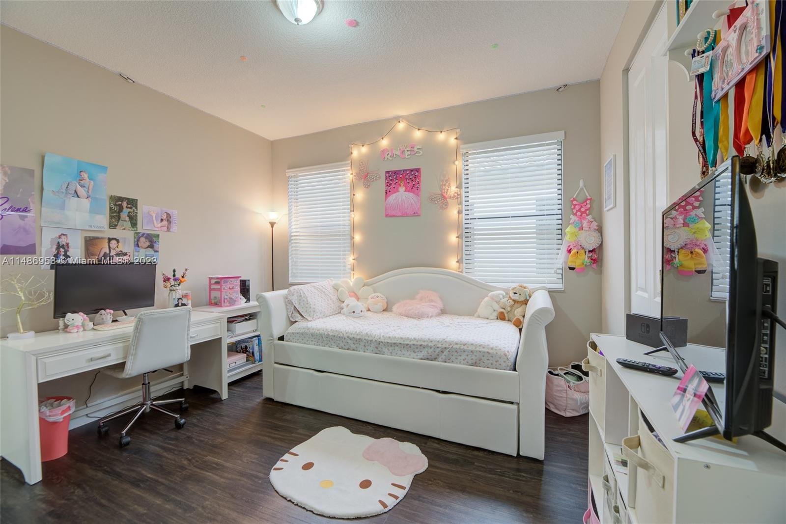 3308 West 95th Terrace Hialeah, FL 33018 - Photo 23 of 43 a bedroom with a bed and a flat screen tv