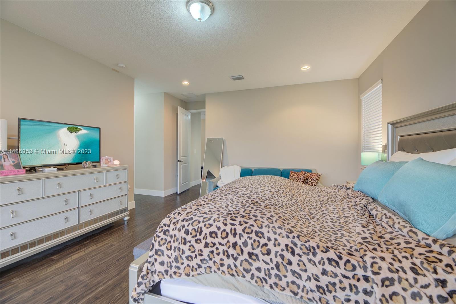 3308 West 95th Terrace Hialeah, FL 33018 - Photo 27 of 43 a bedroom with a bed and a flat screen tv