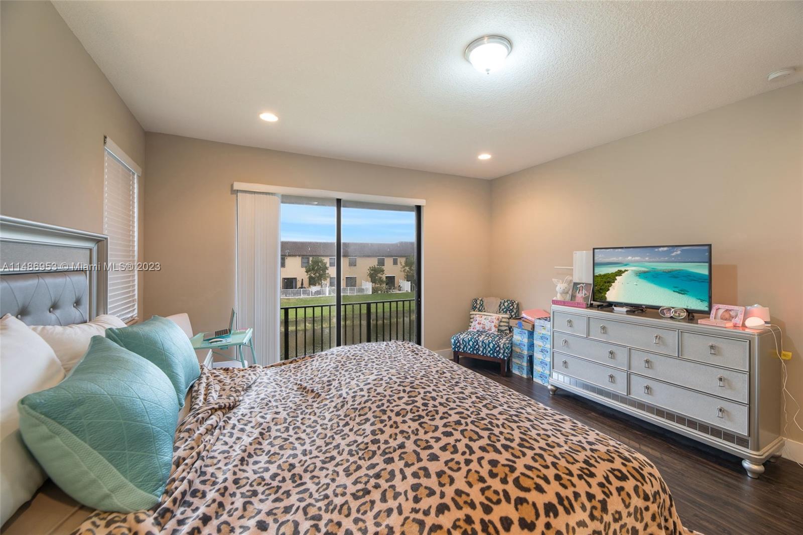 3308 West 95th Terrace Hialeah, FL 33018 - Photo 28 of 43 a bedroom with a bed and a dresser