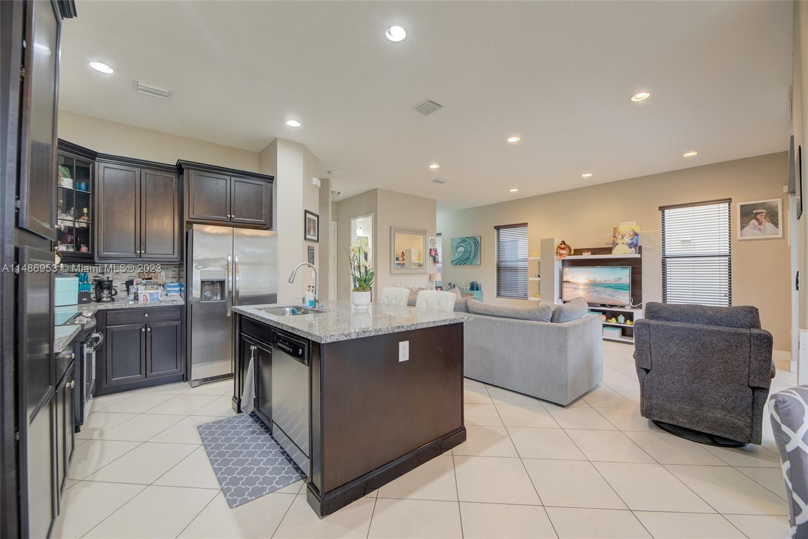 3308 West 95th Terrace Hialeah, FL 33018 - Photo 8 of 43 a kitchen with kitchen island cabinets and refrigerator