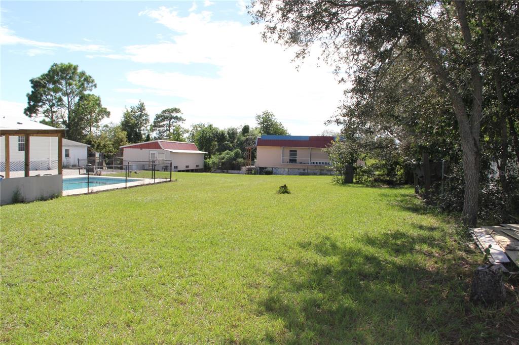 13127 Star Road Brooksville, FL 34613 - Photo 50 of 54 a view of a house with a yard and sitting area
