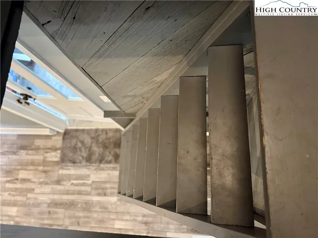 a living room with hard wood flooring and a table