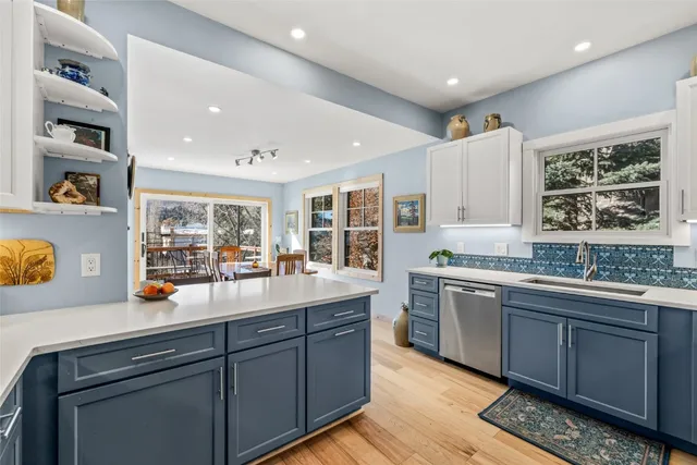a kitchen with stainless steel appliances granite countertop a sink and cabinets
