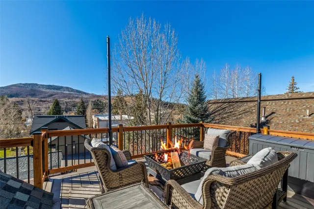 a view of a balcony with two chairs and a potted plant