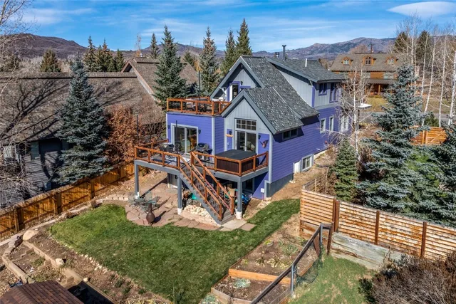 an aerial view of a house with a big yard
