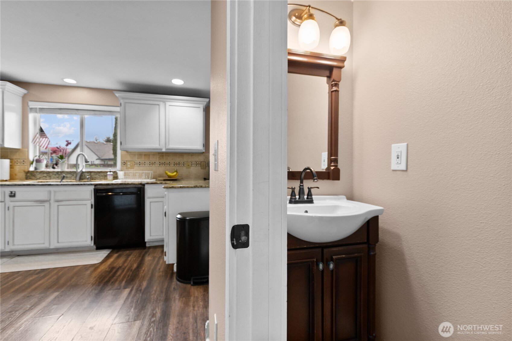 427 Klinger Street Sedro-Woolley, WA 98284 - Photo 11 of 25 a kitchen with kitchen island granite countertop a sink cabinets and wooden floor