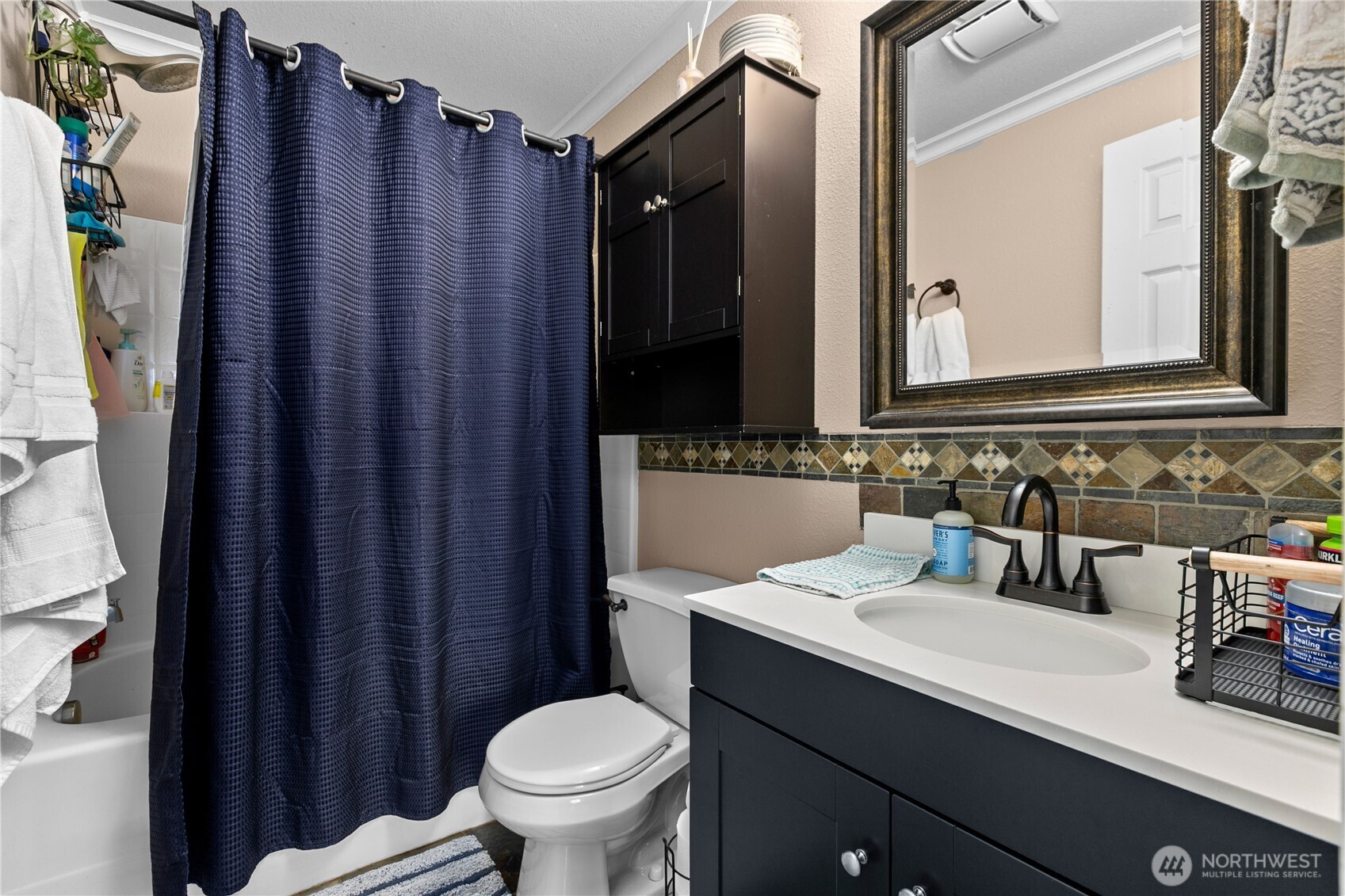 427 Klinger Street Sedro-Woolley, WA 98284 - Photo 17 of 25 a bathroom with a sink a toilet a mirror and shower curtain