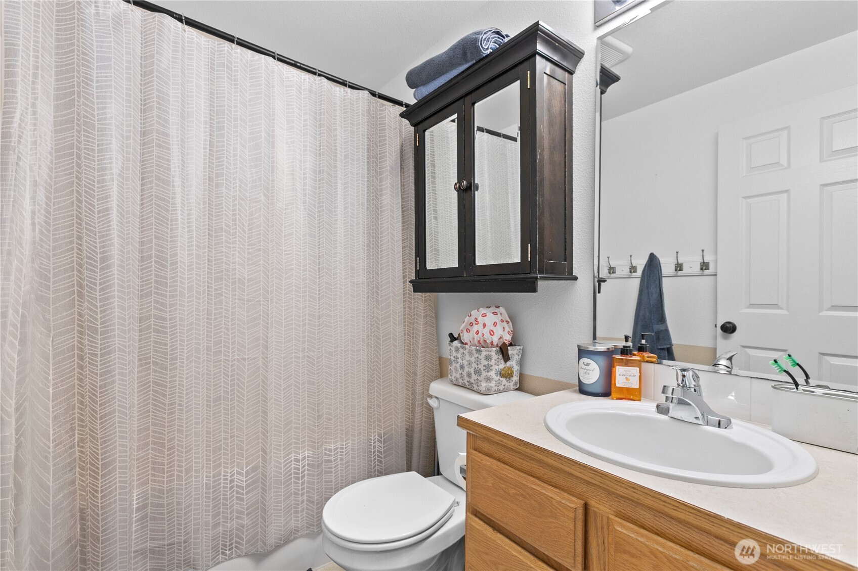427 Klinger Street Sedro-Woolley, WA 98284 - Photo 19 of 25 a bathroom with a sink a toilet and shower curtain