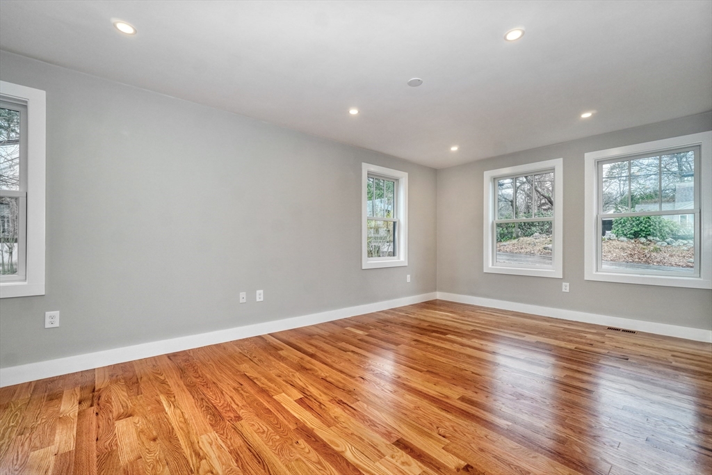 111 Cedar Street Lexington, MA 02421 - Photo 15 of 40 a view of an empty room with wooden floor and a window
