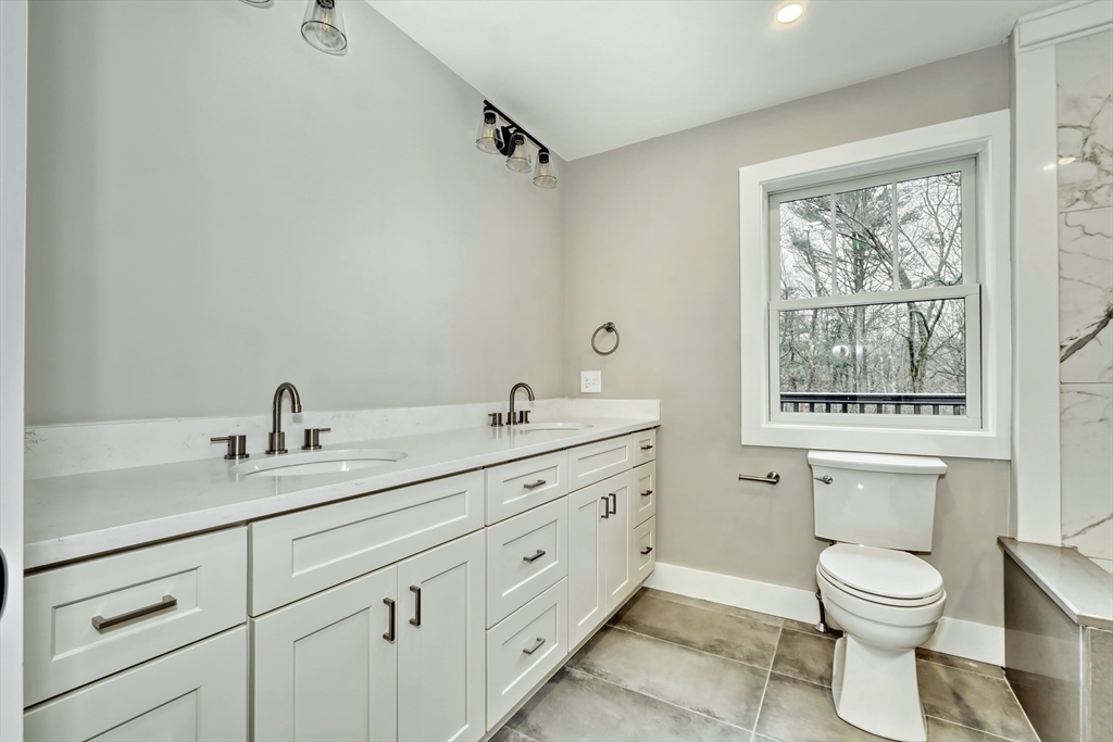 111 Cedar Street Lexington, MA 02421 - Photo 18 of 40 a bathroom with a granite countertop toilet sink and mirror