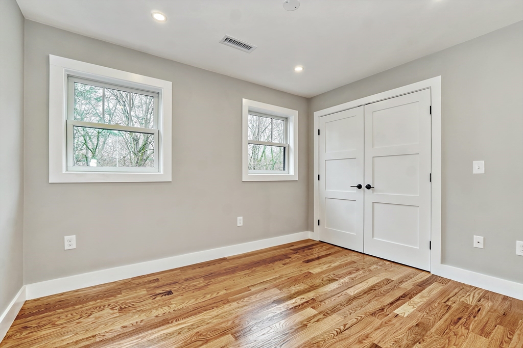 111 Cedar Street Lexington, MA 02421 - Photo 21 of 40 a view of empty room with wooden floor and fan