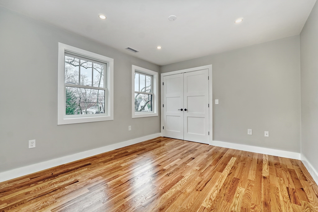 111 Cedar Street Lexington, MA 02421 - Photo 22 of 40 wooden floor in an empty room with a window