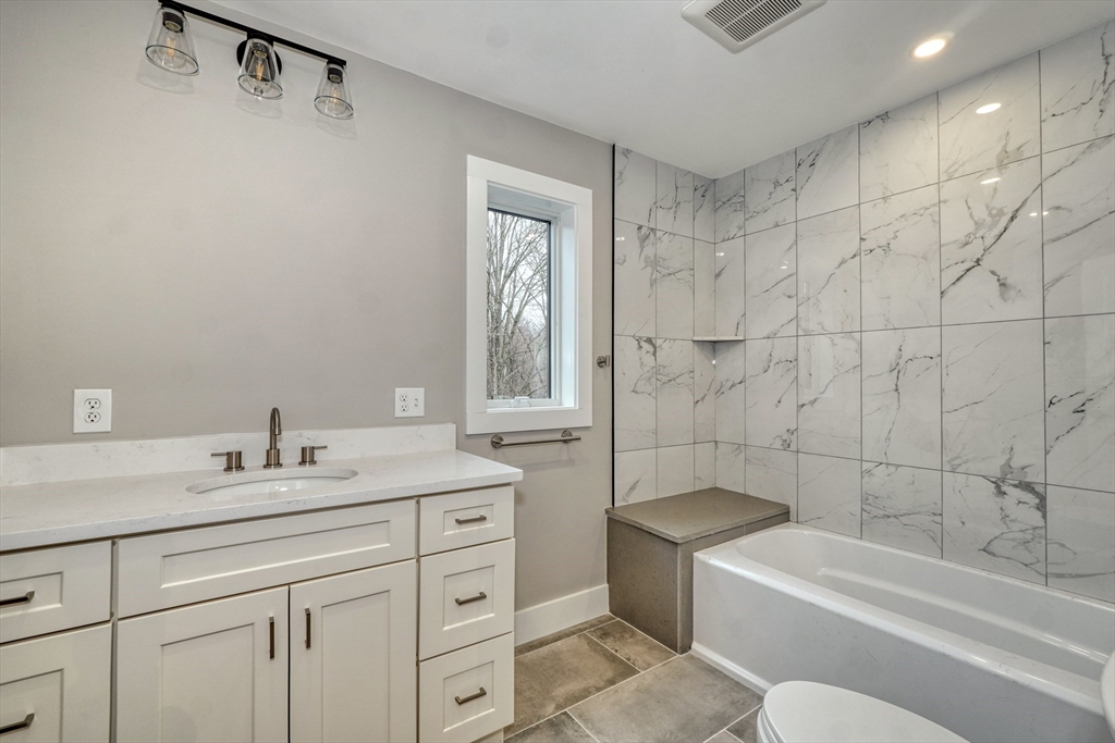 111 Cedar Street Lexington, MA 02421 - Photo 23 of 40 a bathroom with a sink a toilet and bathtub