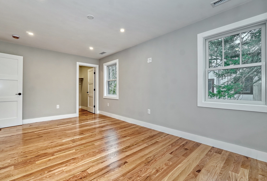 111 Cedar Street Lexington, MA 02421 - Photo 24 of 40 a view of an empty room with wooden floor and a window