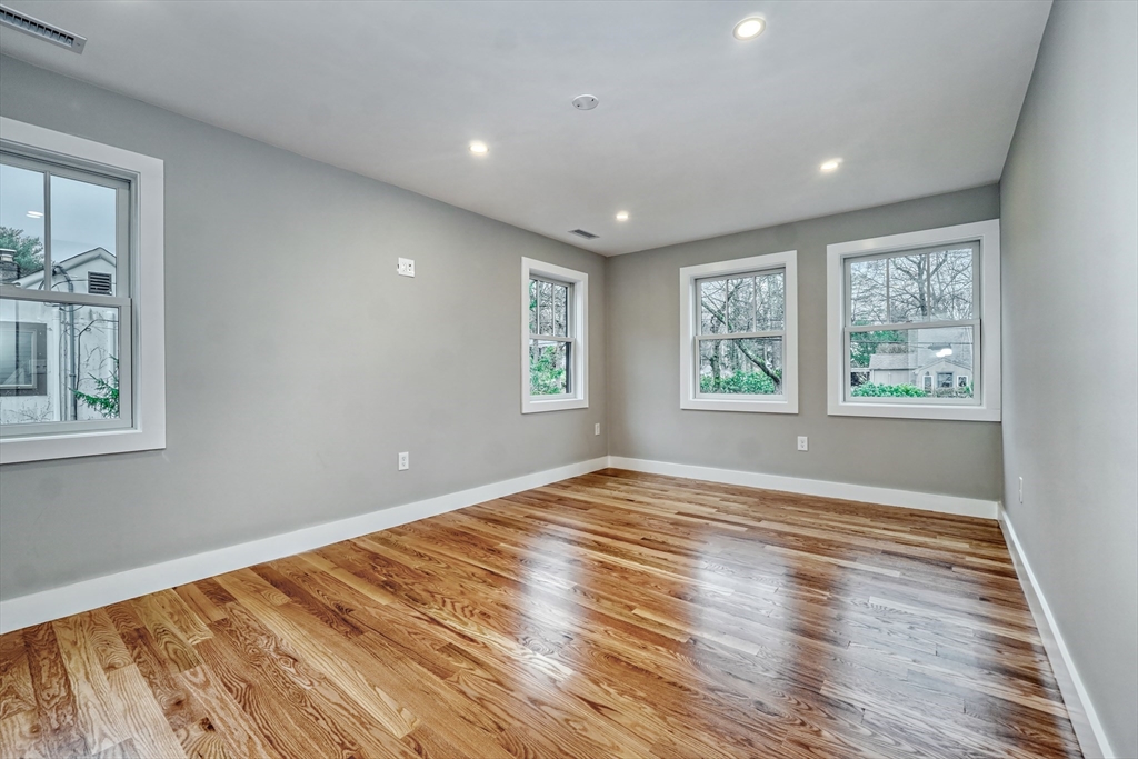 111 Cedar Street Lexington, MA 02421 - Photo 25 of 40 a view of empty room with wooden floor and fan