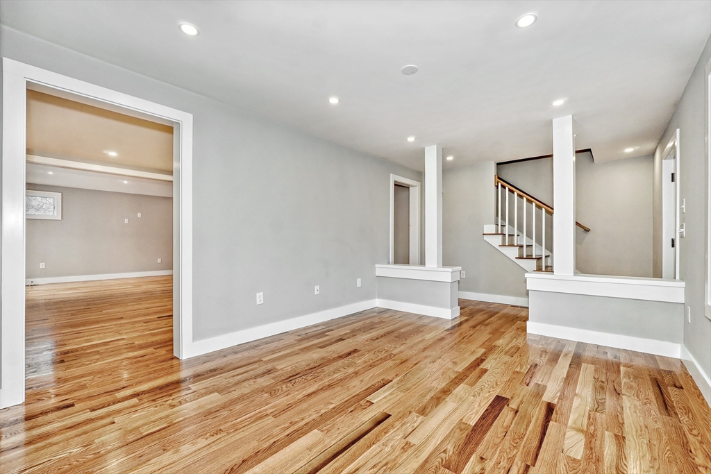 111 Cedar Street Lexington, MA 02421 - Photo 3 of 40 a view of an empty room with wooden floor and a window