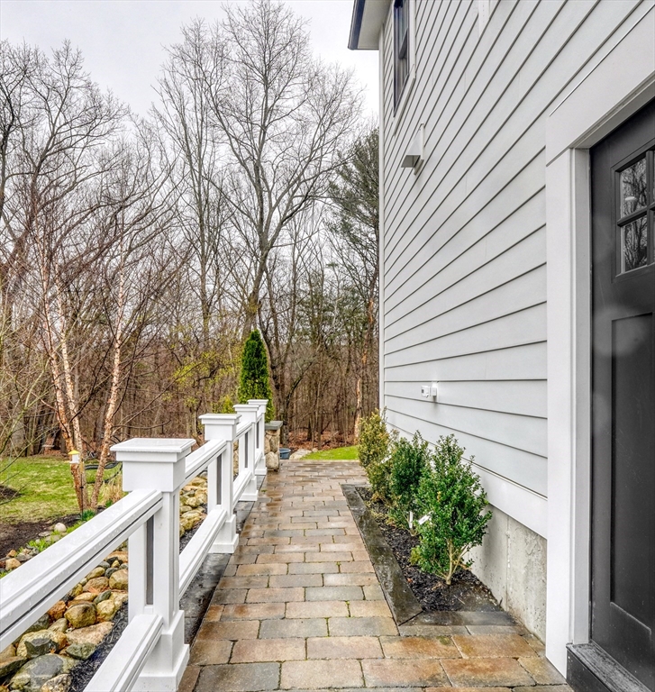 111 Cedar Street Lexington, MA 02421 - Photo 35 of 40 a view of a pathway with a wrought fence