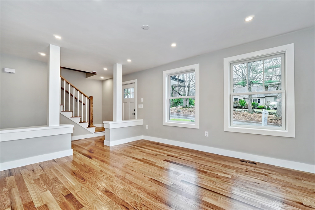 111 Cedar Street Lexington, MA 02421 - Photo 4 of 40 a view of an empty room with wooden floor and a window