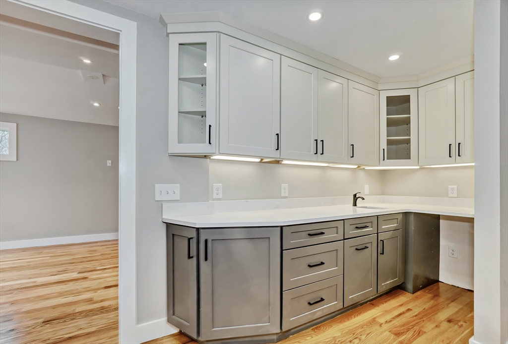 111 Cedar Street Lexington, MA 02421 - Photo 9 of 40 a kitchen with stainless steel appliances granite countertop a sink and dishwasher with white cabinets