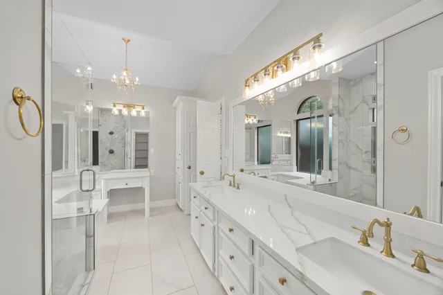 a large bathroom with a granite countertop sink mirror and a shower