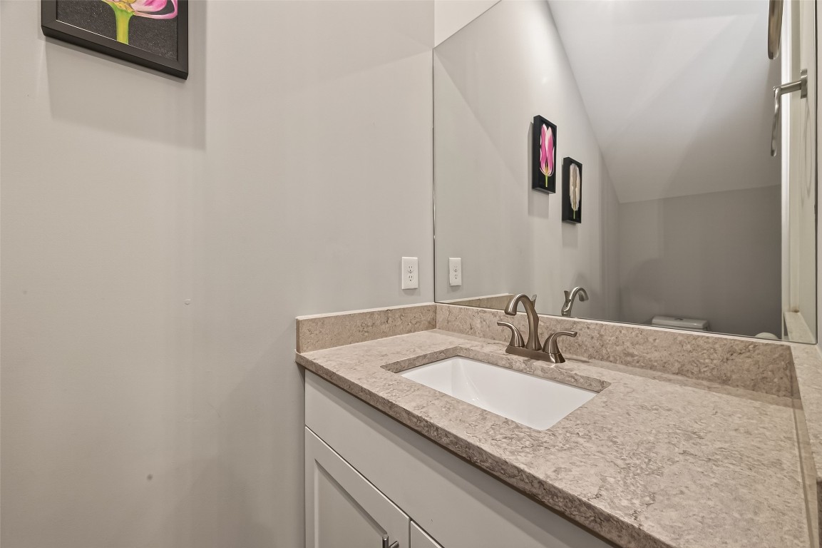604 West Pierce Street Houston, TX 77019 - Photo 14 of 33 a bathroom with a granite countertop sink and a mirror