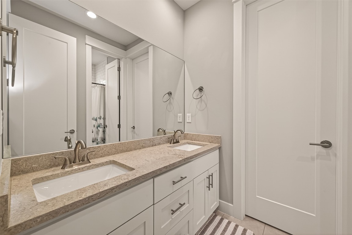 604 West Pierce Street Houston, TX 77019 - Photo 19 of 33 a bathroom with a granite countertop sink and a mirror