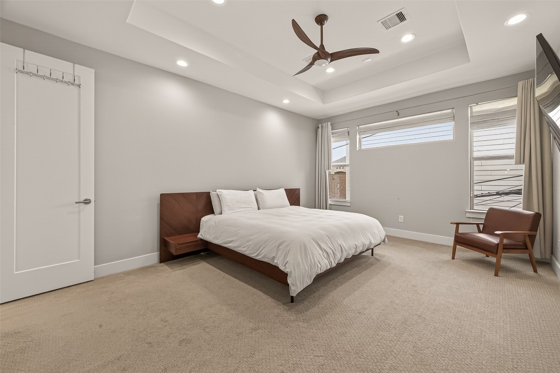 604 West Pierce Street Houston, TX 77019 - Photo 23 of 33 a spacious bedroom with a bed a couch and a couch