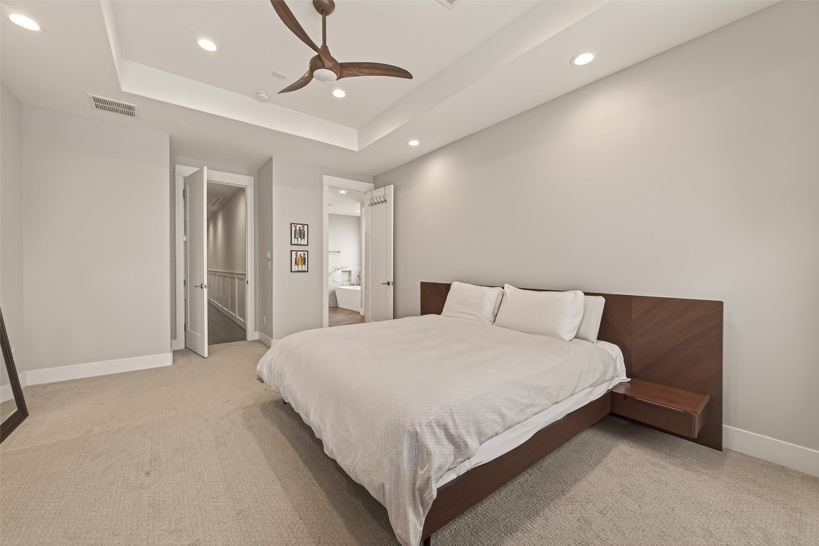 604 West Pierce Street Houston, TX 77019 - Photo 24 of 33 a spacious bedroom with a bed and a chandelier