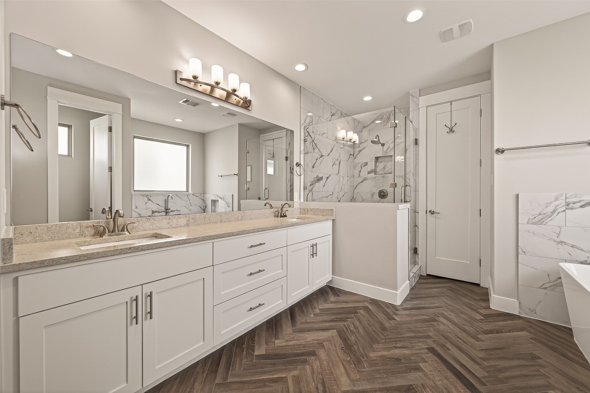 604 West Pierce Street Houston, TX 77019 - Photo 25 of 33 a spacious bathroom with a double vanity sink a large mirror a shower and vanity
