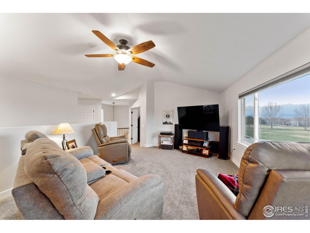 6607 Echo Circle Firestone, CO 80504 - Photo 13 of 40 a living room with furniture and a flat screen tv