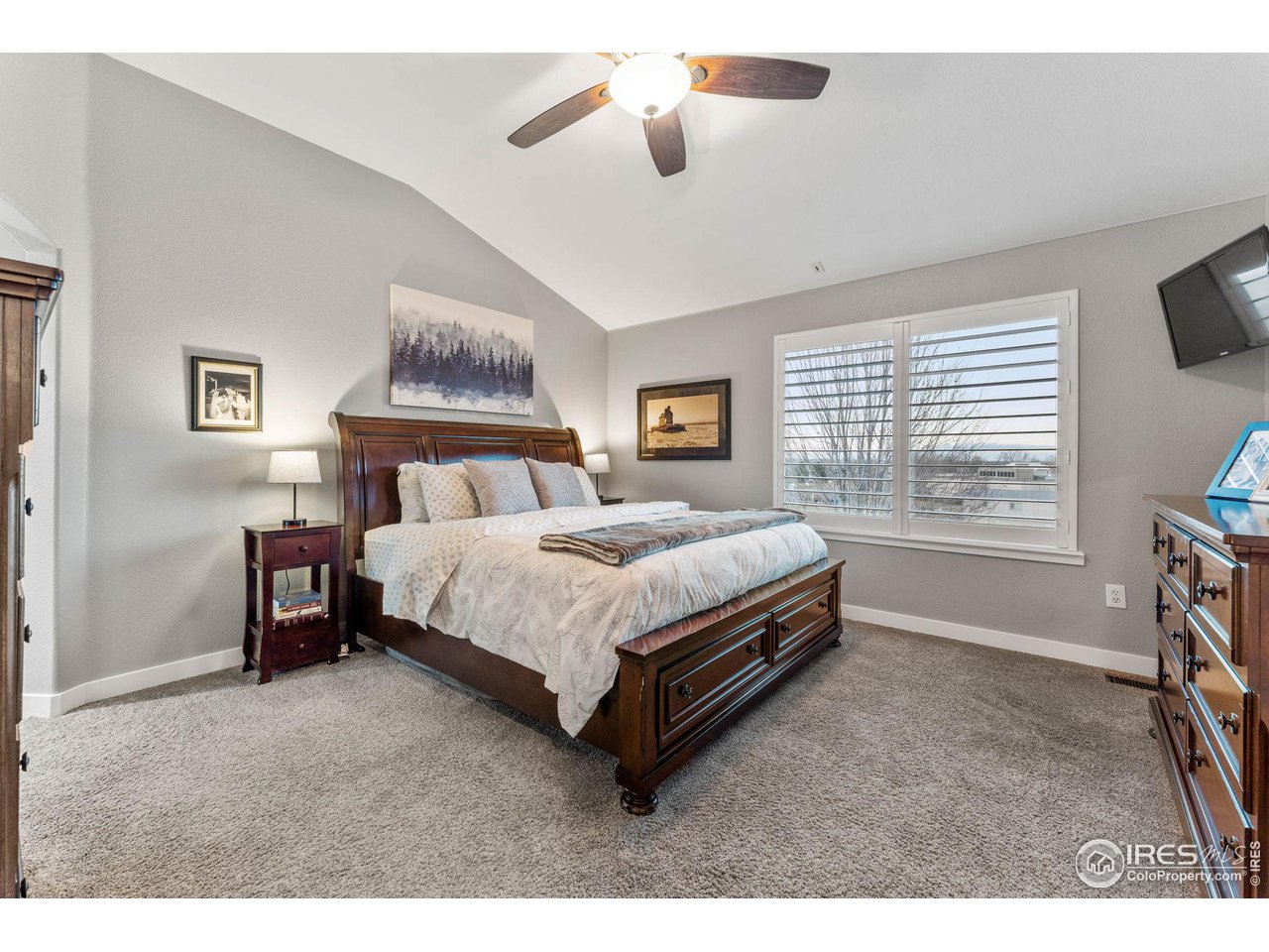 6607 Echo Circle Firestone, CO 80504 - Photo 15 of 40 a bedroom with a bed and ceiling fan