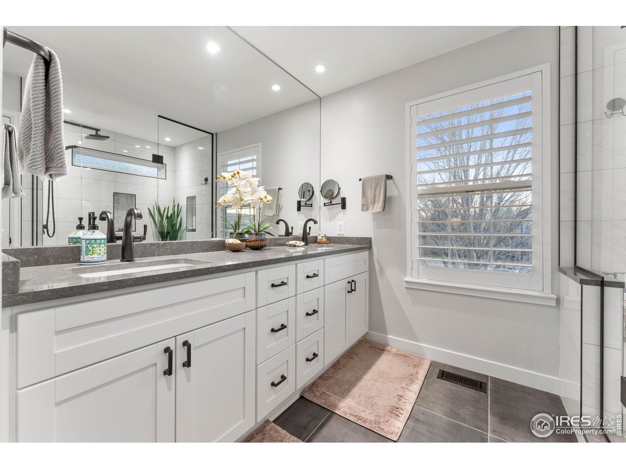 6607 Echo Circle Firestone, CO 80504 - Photo 18 of 40 a bathroom with a double vanity sink and a mirror