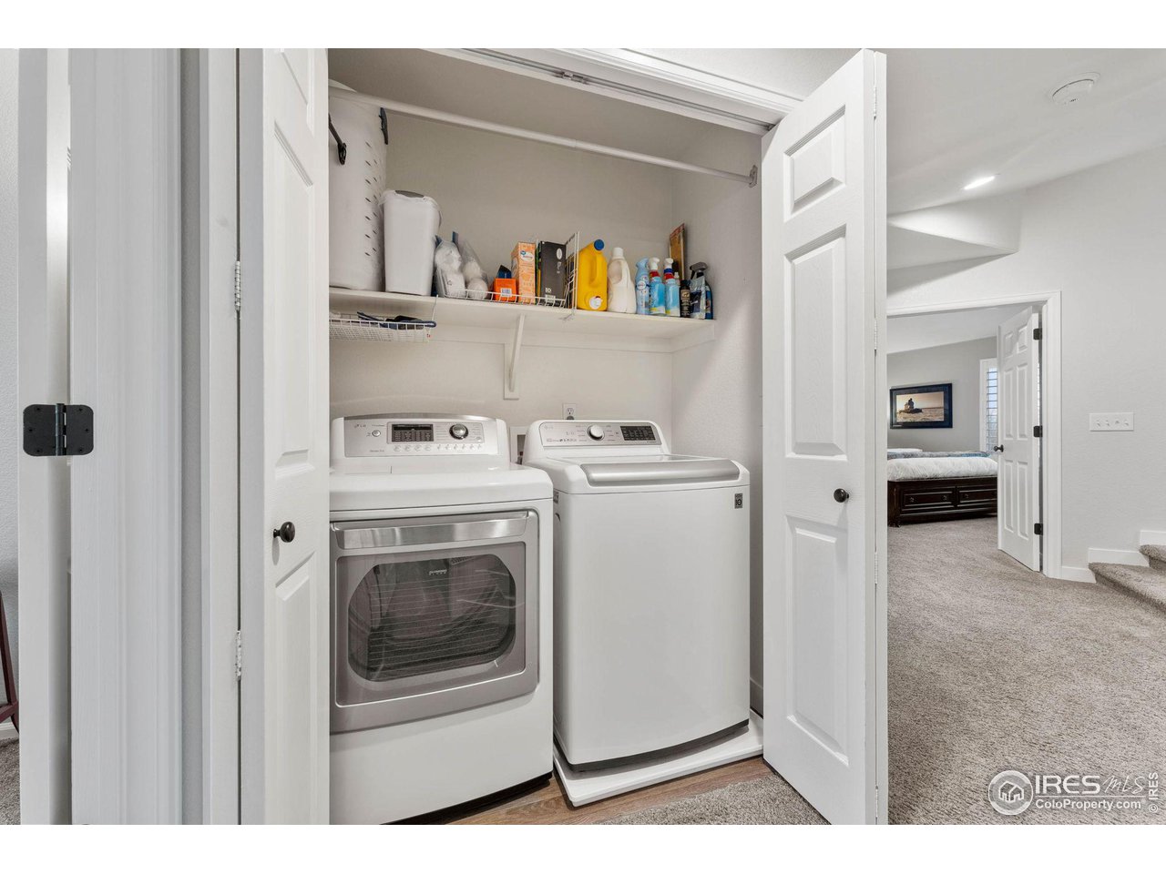 6607 Echo Circle Firestone, CO 80504 - Photo 22 of 40 a view of washer and dryer with kitchen in the background