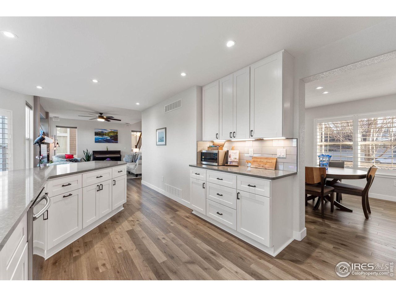 6607 Echo Circle Firestone, CO 80504 - Photo 7 of 40 a kitchen with granite countertop white cabinets and white appliances