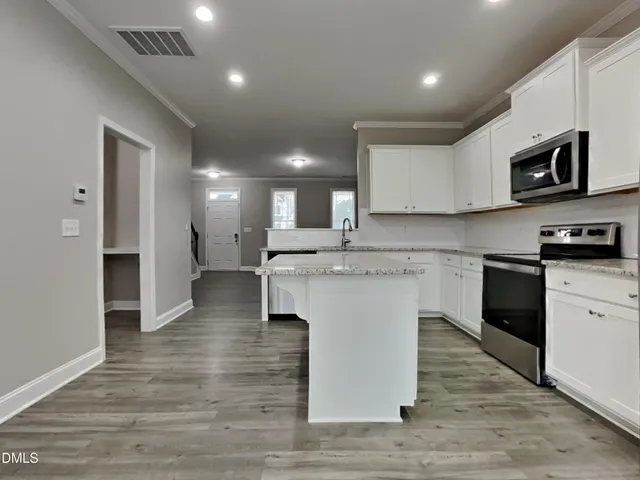 a kitchen with a sink microwave and refrigerator
