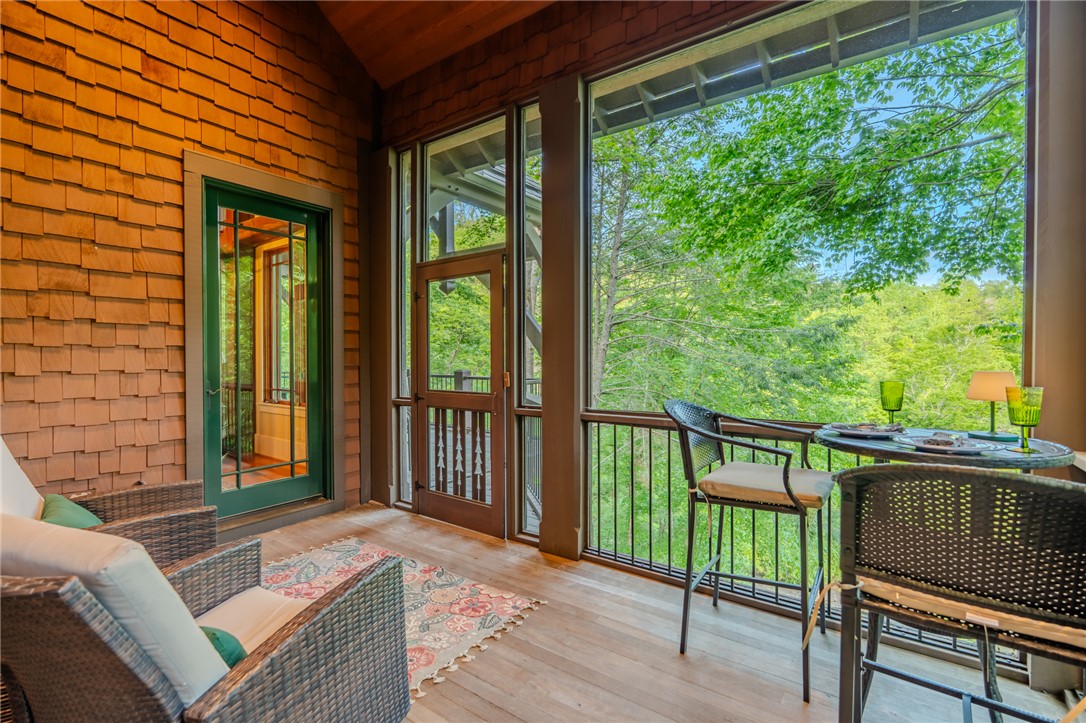 102 State Rd S-39-143 Sunset, SC 29685 - Photo 21 of 47 This inviting porch offers tranquil views of lush trees, perfect for serene outdoor moments.