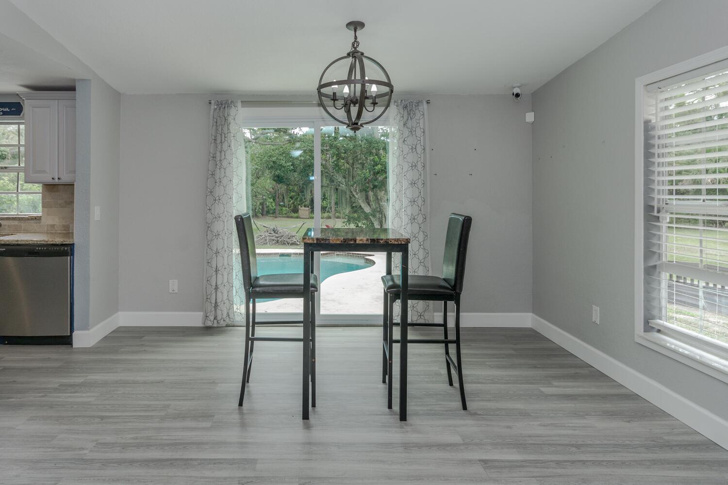9709 154th Road North Jupiter, FL 33478 - Photo 8 of 37 Dinning Area Leading out to Pool