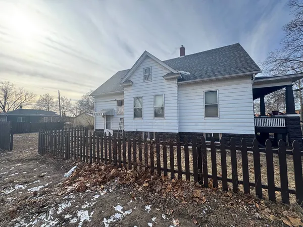 a view of a house with wooden fence