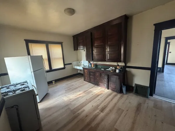 a kitchen with a refrigerator a sink and cabinets