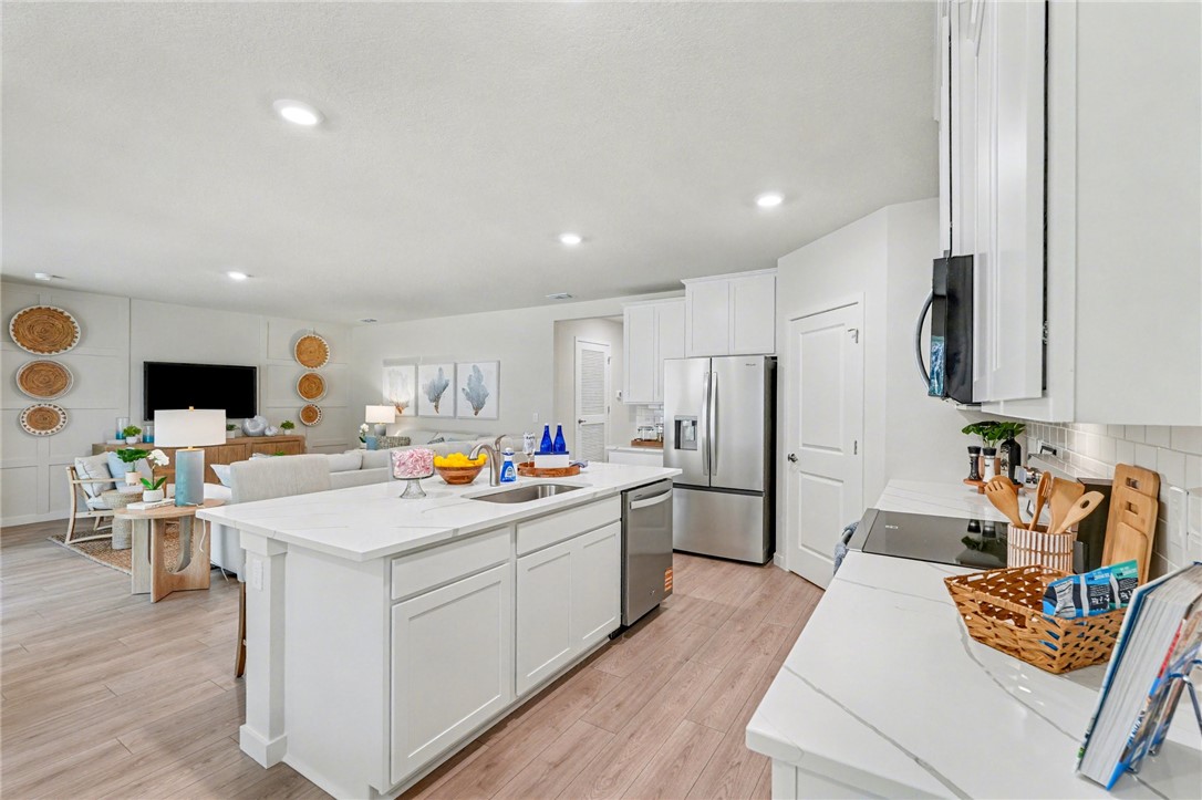 793 George Street Sebastian, FL 32958 - Photo 11 of 22 a kitchen that has a lot of cabinets a sink and appliances in it