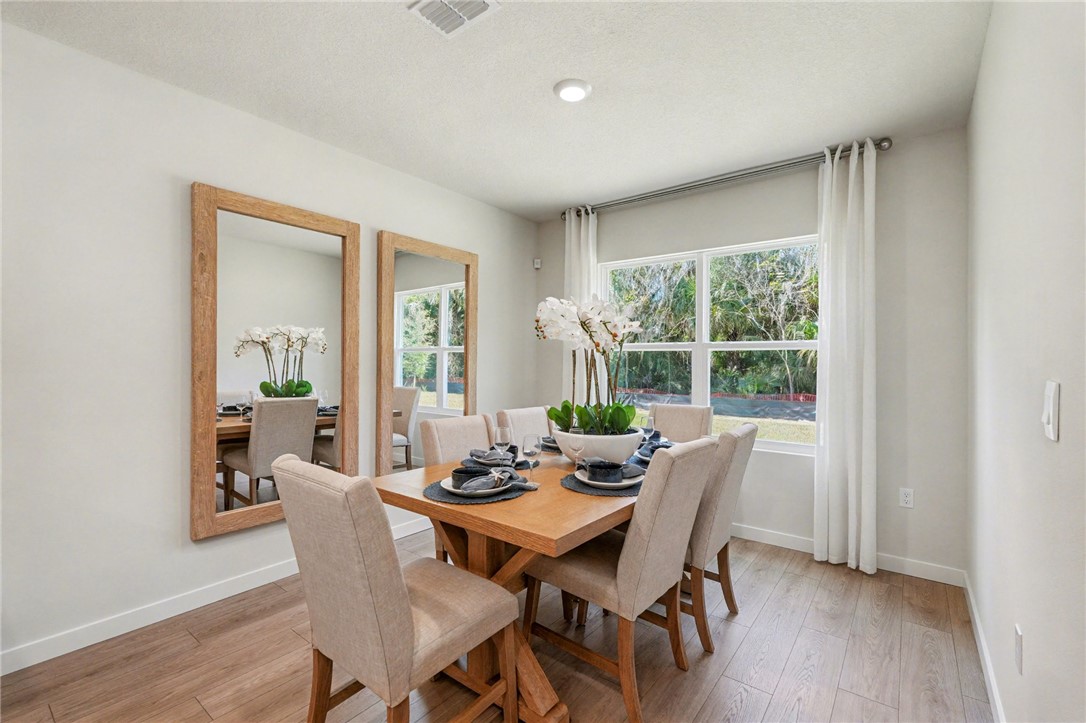793 George Street Sebastian, FL 32958 - Photo 13 of 22 a view of a dining room with furniture window and wooden floor