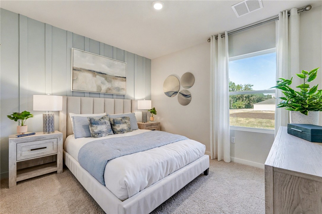 793 George Street Sebastian, FL 32958 - Photo 16 of 22 a bedroom with a bed and a potted plant