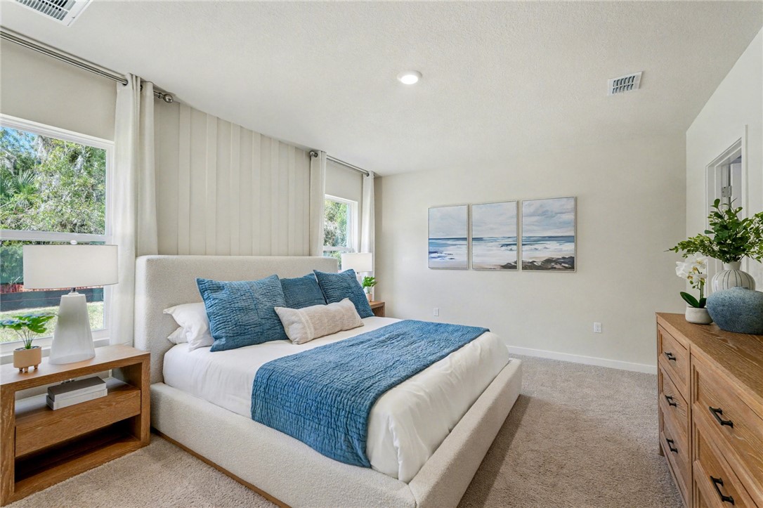 793 George Street Sebastian, FL 32958 - Photo 17 of 22 a bedroom with a large bed and a potted plant